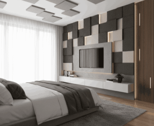 A modern bedroom featuring a stylish media wall with a grid pattern of acoustic panels in varying shades of grey and beige, some with subtle backlighting. A wall-mounted TV is centered, and above it, more square acoustic panels are arranged artistically on the ceiling.