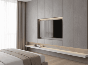 A hotel-style recessed media wall where the TV screen is perfectly flush (even) with the surrounding wall paneling. This clean, minimalist design requires built-in stud framing to hide the TV bracket and all cables entirely behind the wall.